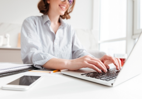 brunette woman typing email laptop computer while sitting home selective focus hand