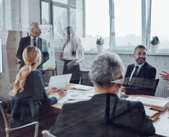 confident businessman conducting presentation while having staff meeting board room